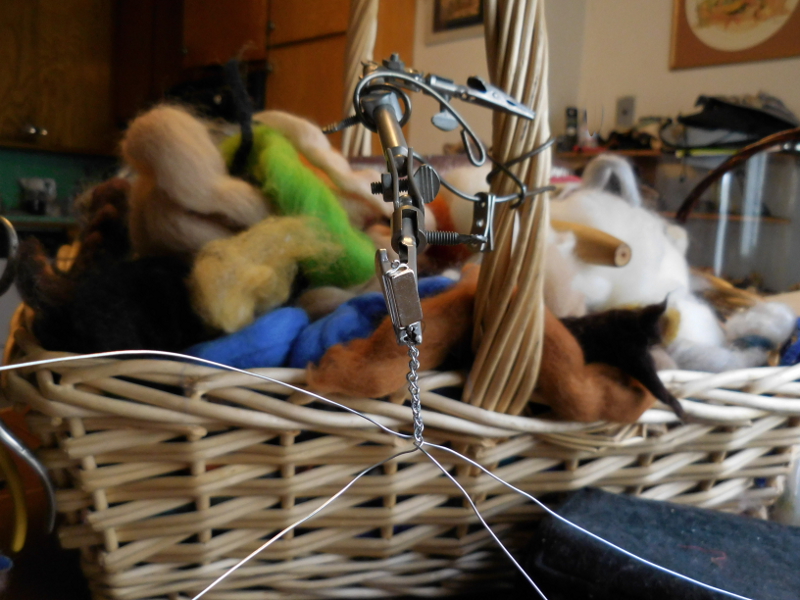 Starting the real thing simple but tedious, with moments of fear. (Eyeball, meet end of wire. Nooo.) The Rube Goldberg holder started out as an X-acto third hand and a coat hanger. Pic #4: Real braid in progress