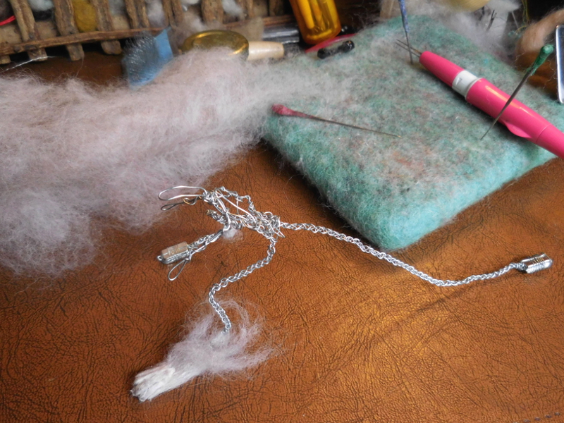 This is the fourth version of a foot; still not perfect, but with enough wiggle room to keep working on it. (The key turned out to be making a thin sheet of felted wool, dipping that in the wax pot, then applying it to the foot when slightly cooled but still soft and moldable into a sock with toes.) Pic #8: New foot