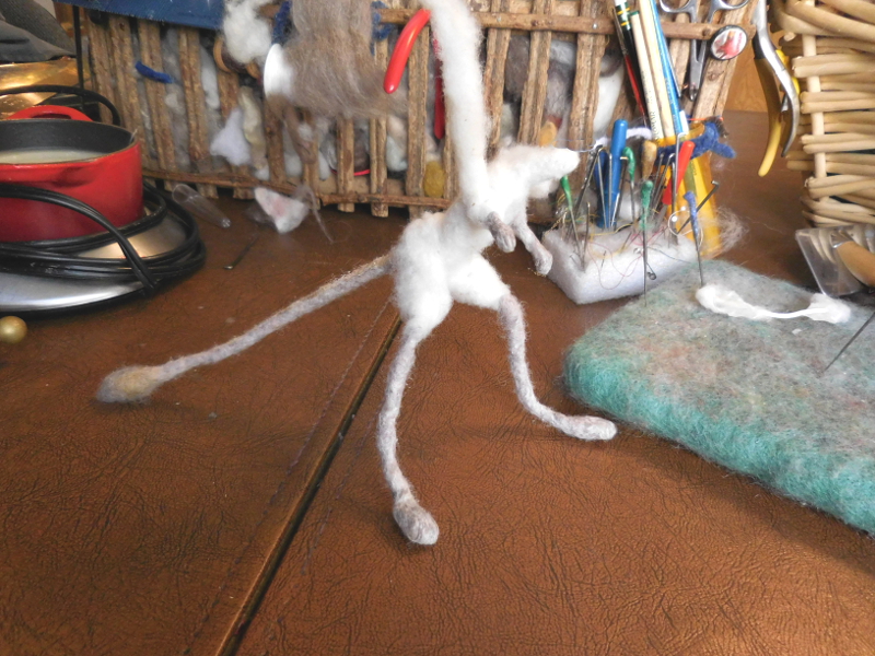 The wool plume was slightly felted before adding it on so as to bulk up faster. (The hips have received the same treatment.) Pic #15: More shoulder wrapping