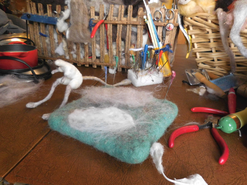 Two puffs of wool, selected for the inner and outer ear color and sized to go with the armature (visible at lower right). Pic #16