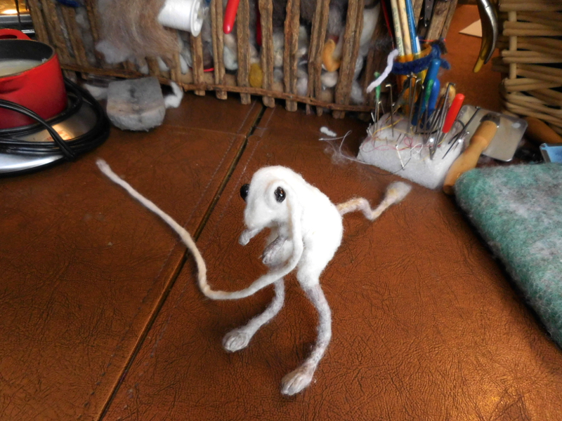 The eyes need a solid, fuzz-free supporting ring. The cord being applied here is core wool, needle felted and then wet felted for extreme density. Pic #24: Building up the eye socket