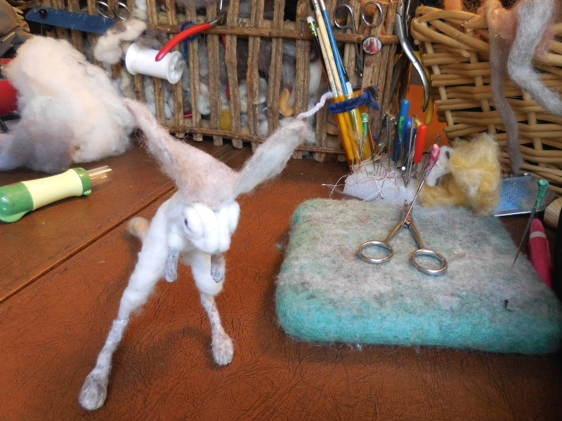 First steps in anchoring the ears: felt them down in front, and then pull the fabric back toward the sides and felt it in place. Pic #30: Ears on
