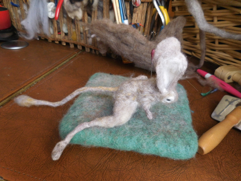 After a night’s sleep, it was clear that the problem was excess bulk which could no longer be cut away easily, given the thin layer of color. Here he is spreadeagled on the felting cushion for serious needlework. Pic #36: New round of compression