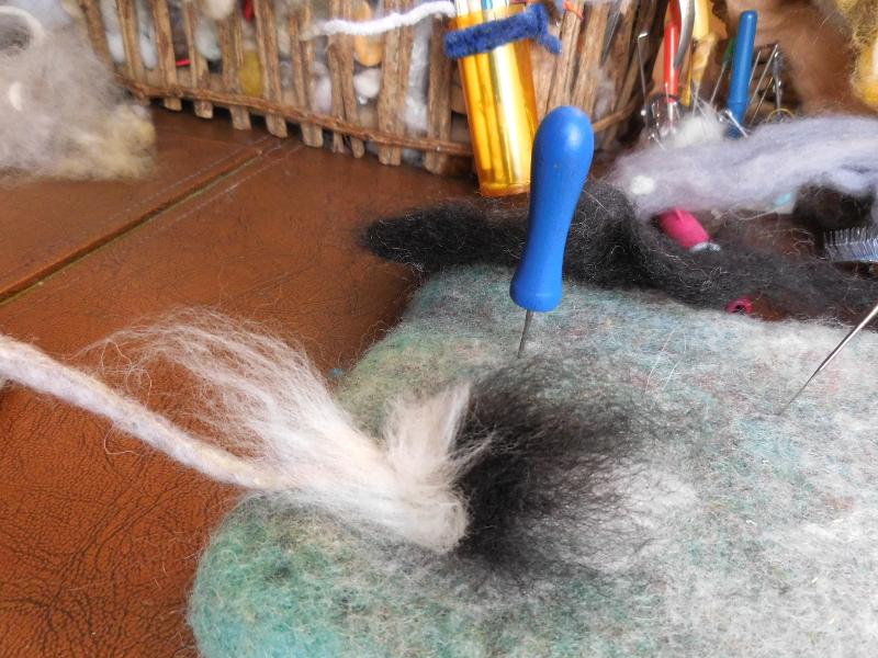 Setting long hair or fur involves felting crossways through the middle of the tuft... Pic #40: Adding tail hair