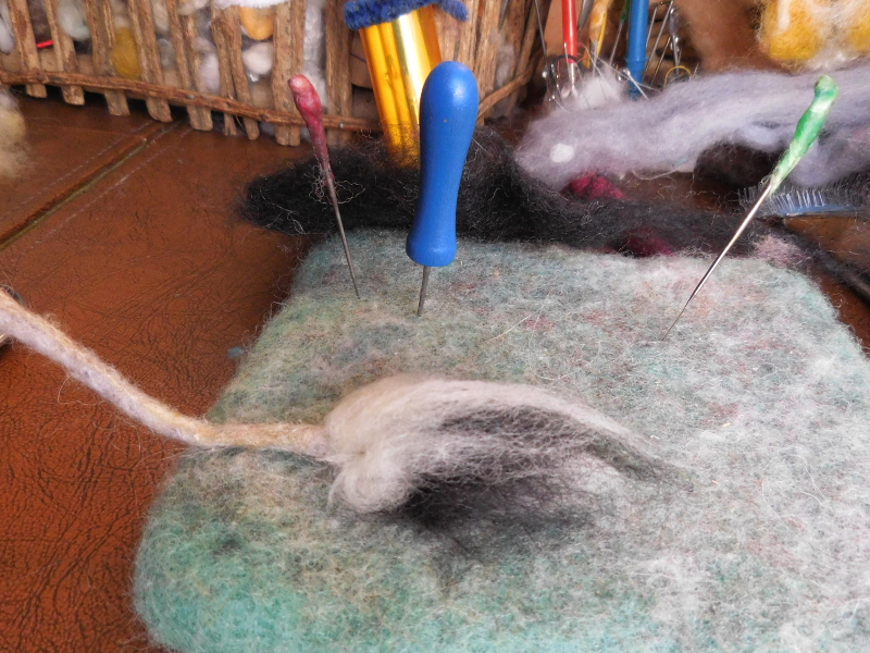 ...then folding the tuft over and felting through the fold. Pic #41: Felting down the final tuft layer