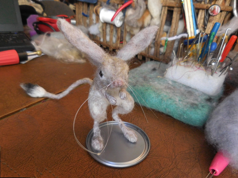 Sewing in a strand of horsehair for whiskers. Note the dab of glue on the knot; pulled through into the muzzle, it will keep the hairs from sliding out again. Pic #43: Whiskers