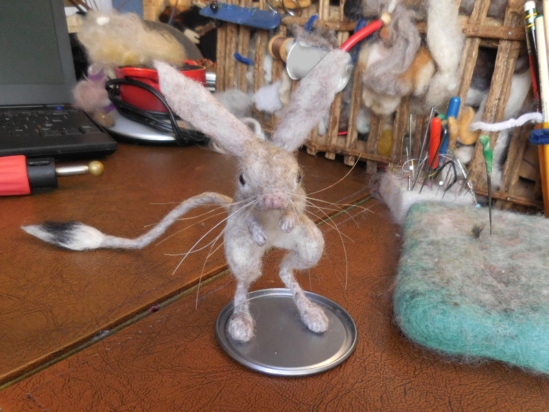 With whiskers finished and trimmed, the little guy feels ready to take on the world. A bit of extra hand-rolling gives the tail tuft a nice touch. Unfortunately, I didn’t notice how much his nose looks like a pair of buttocks.... Pic #44: Final bench shot